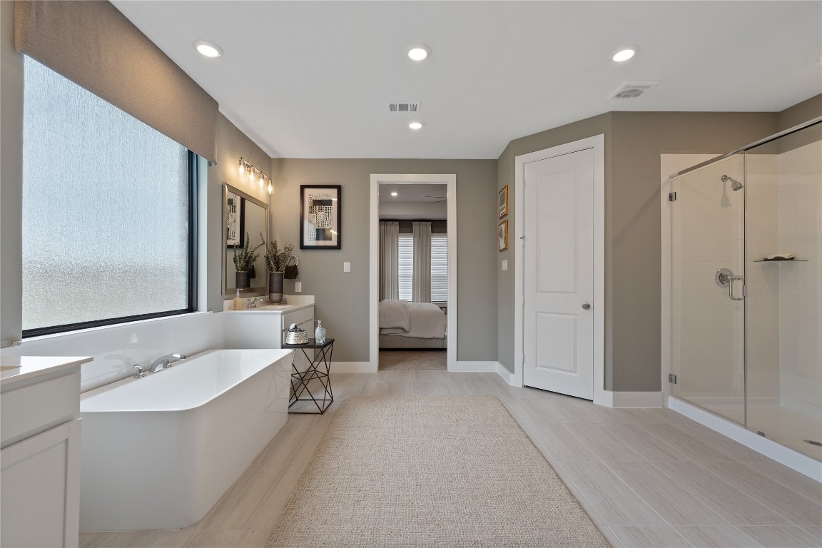 813 Green Ash Way Waller, TX 77484 - Photo 19 of 41 a bathroom with a double vanity sink tub and mirror