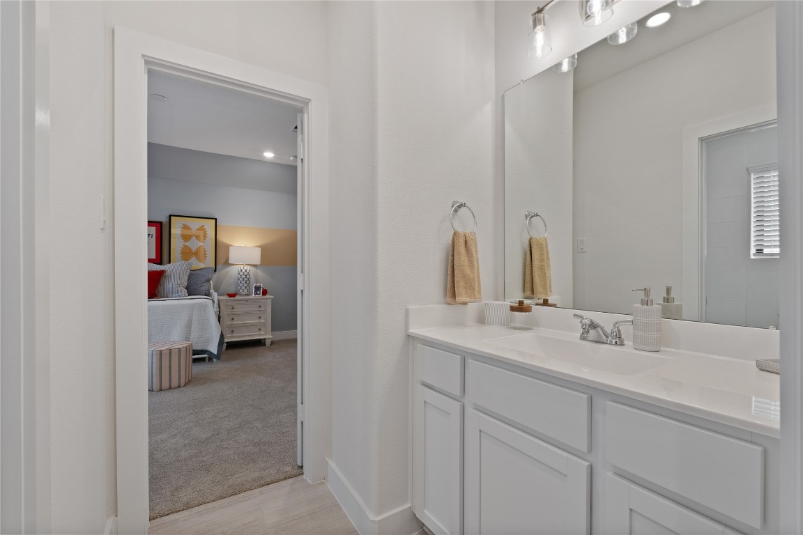813 Green Ash Way Waller, TX 77484 - Photo 37 of 41 a en suite bathroom with a double vanity sink and a mirror