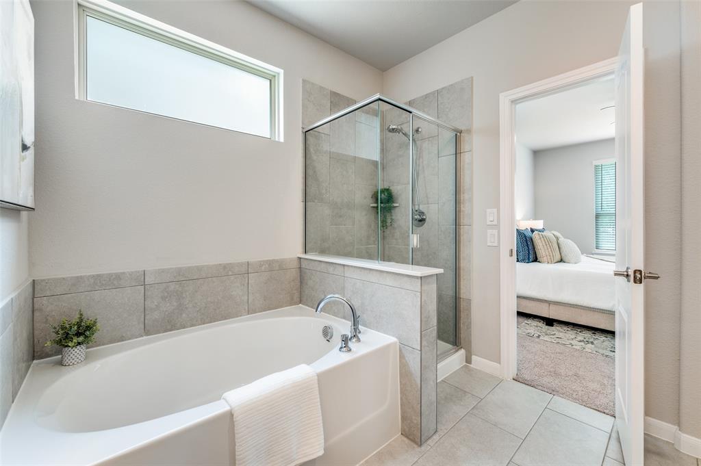 1240 Morning Ridge Trail Aubrey, TX 76227 - Photo 13 of 25 Ensuite bathroom with a bath, a stall shower, and tile patterned floors