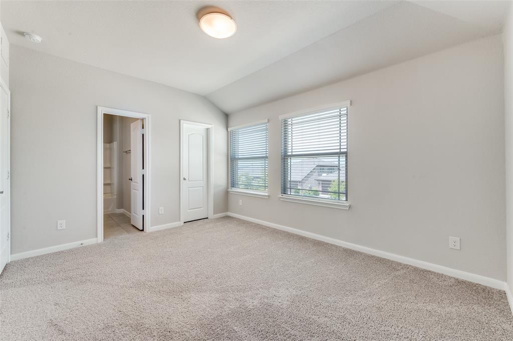 1240 Morning Ridge Trail Aubrey, TX 76227 - Photo 15 of 25 Unfurnished bedroom with light colored carpet, lofted ceiling, and ensuite bath