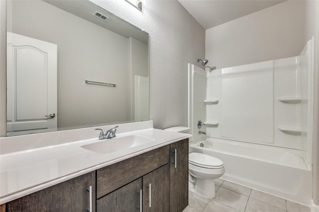 1240 Morning Ridge Trail Aubrey, TX 76227 - Photo 16 of 25 Bathroom featuring light tile patterned floors, shower combination, and vanity