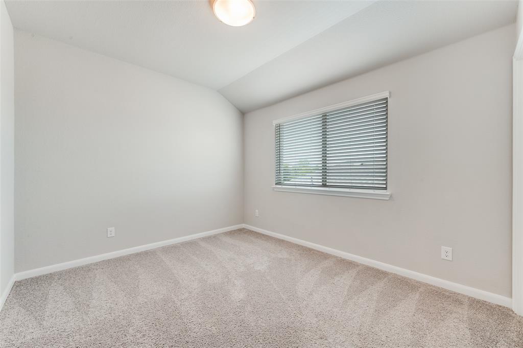 1240 Morning Ridge Trail Aubrey, TX 76227 - Photo 18 of 25 Carpeted spare room with baseboards and vaulted ceiling