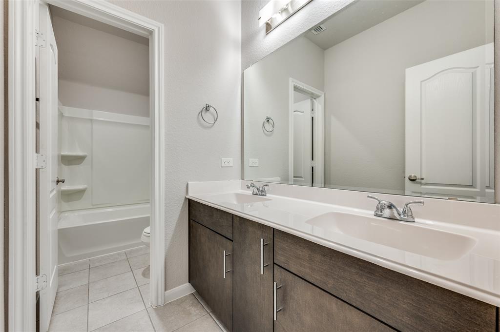 1240 Morning Ridge Trail Aubrey, TX 76227 - Photo 19 of 25 Bathroom featuring light tile patterned floors, double vanity, and shower / tub combination