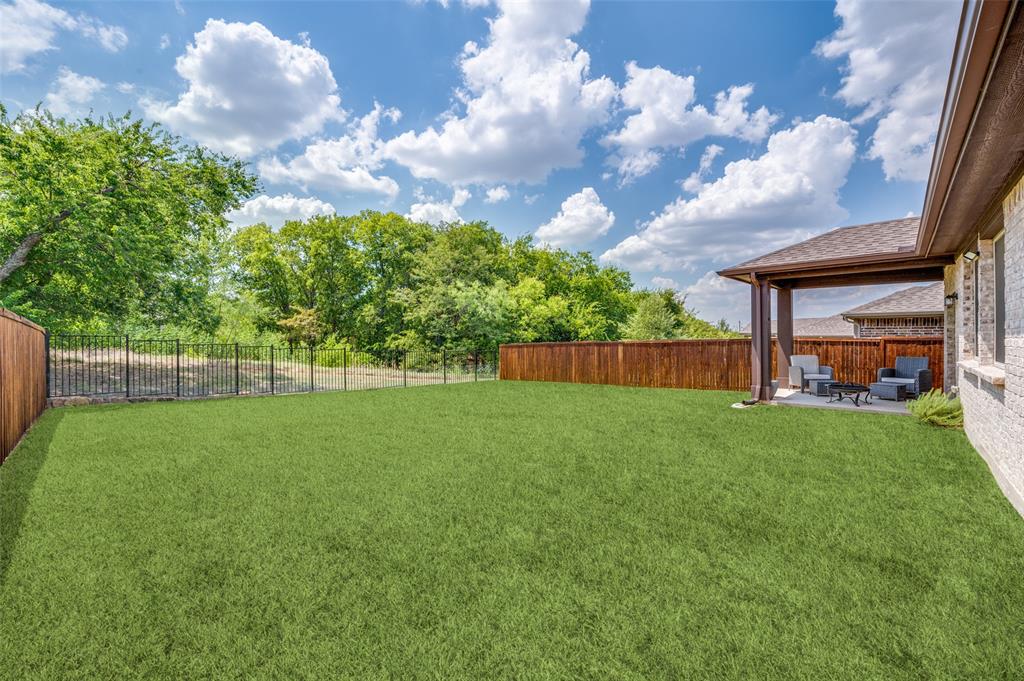 1240 Morning Ridge Trail Aubrey, TX 76227 - Photo 21 of 25 Fenced backyard with a patio area