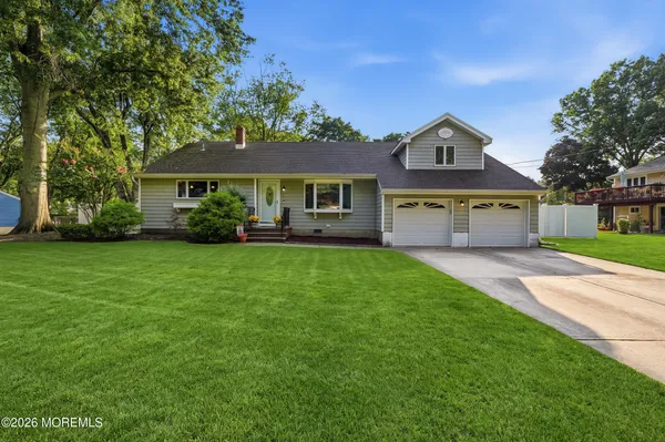 a front view of house with yard and green space