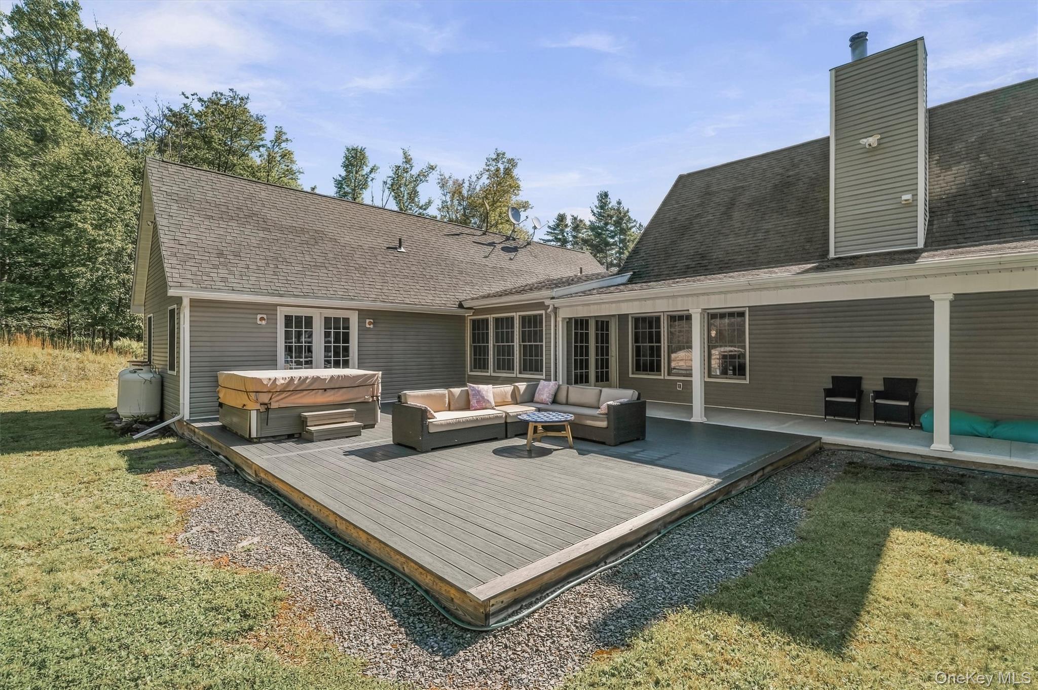 705 Swamp Pond Road Narrowsburg, NY 12764 - Photo 35 of 49 back yard deck with hot tub and lounge area