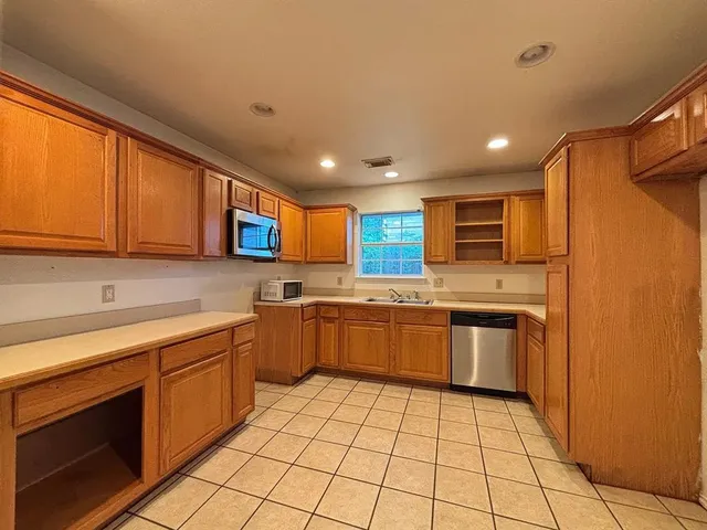 a kitchen with stainless steel appliances granite countertop a sink and cabinets