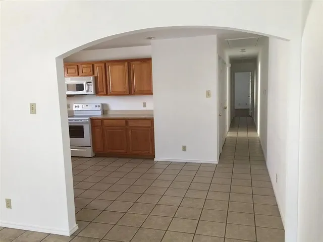 a view of a kitchen from the hallway