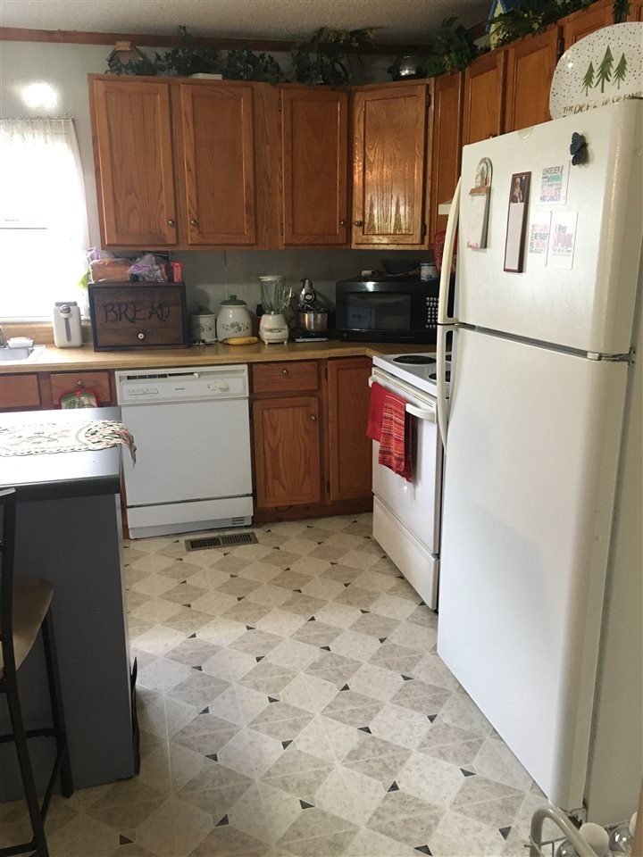 1502 Ladd Springs Road Southeast Cleveland, TN 37323 - Photo 14 of 19 a kitchen with a refrigerator and a stove top oven