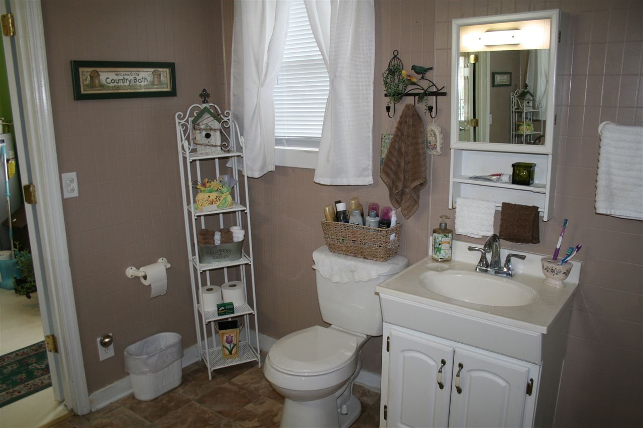 1502 Ladd Springs Road Southeast Cleveland, TN 37323 - Photo 17 of 19 a bathroom with a toilet sink and mirror