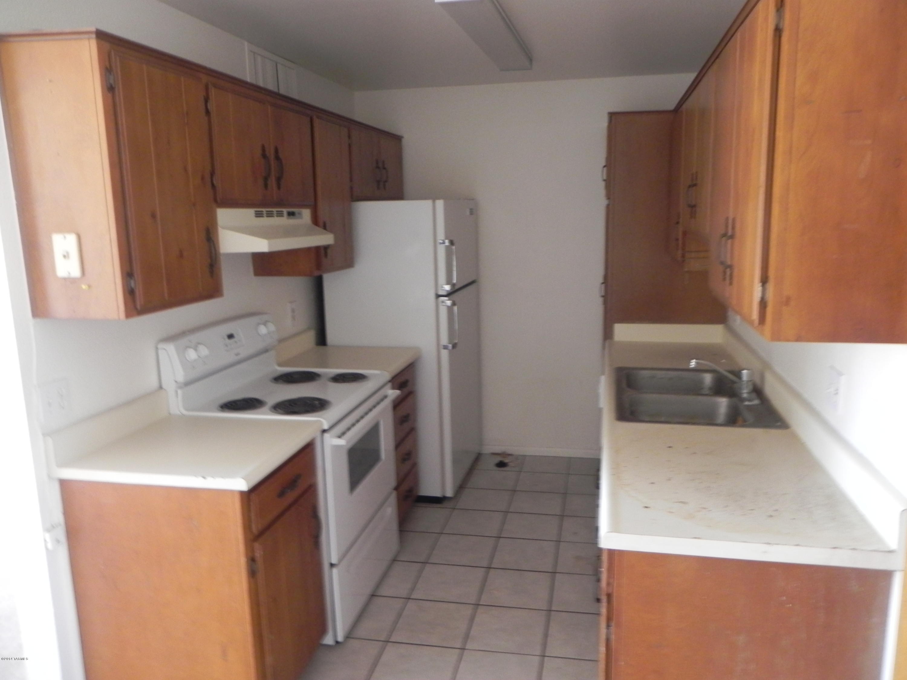 6625 East Golf Links Road, Unit 2 Tucson, AZ 85730 - Photo 2 of 14 a kitchen with a sink a stove and a refrigerator