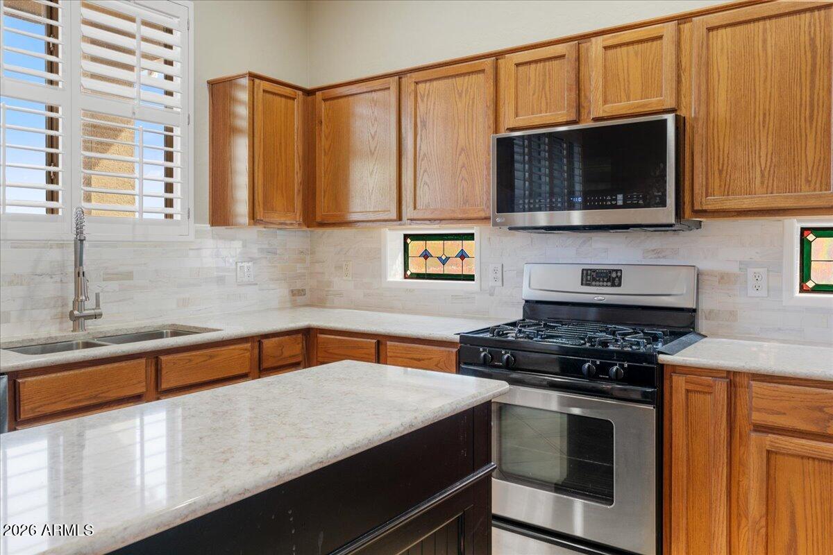 892 West Deep Gorge Road Camp Verde, AZ 86322 - Photo 12 of 38 a kitchen with stainless steel appliances a stove a microwave and cabinets