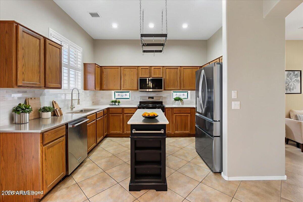 892 West Deep Gorge Road Camp Verde, AZ 86322 - Photo 14 of 38 a kitchen with granite countertop a refrigerator and a stove top oven