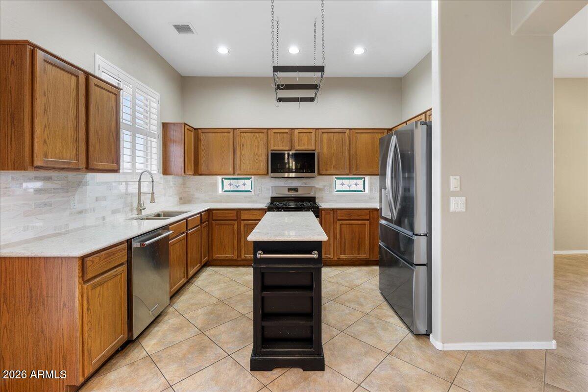 892 West Deep Gorge Road Camp Verde, AZ 86322 - Photo 15 of 38 a kitchen with stainless steel appliances granite countertop a stove a sink and a refrigerator
