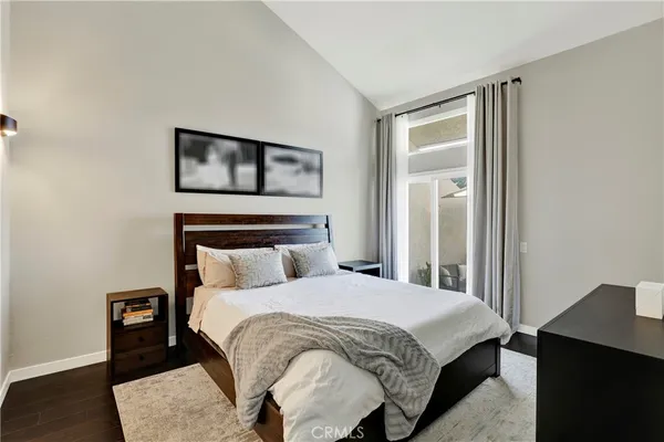 a bedroom with a bed and a night stand