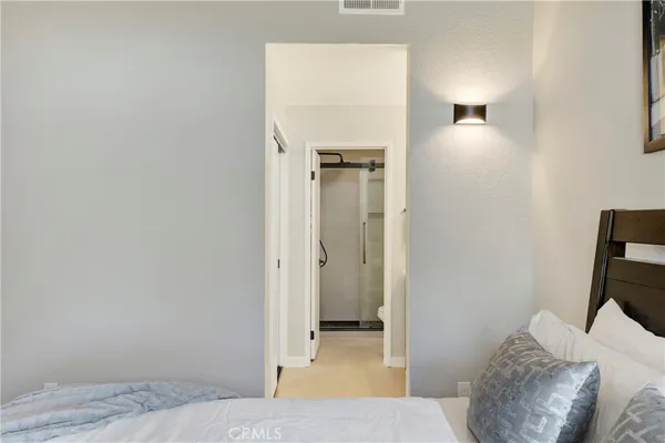 a bedroom with a bed and a mirror