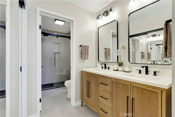 a bathroom with a double vanity sink mirror and double