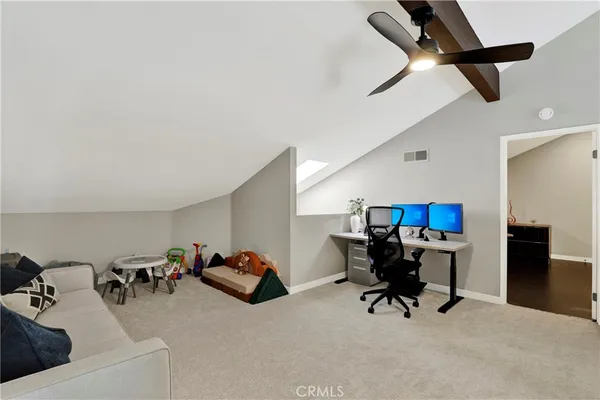a living room with furniture and a air conditioner vent