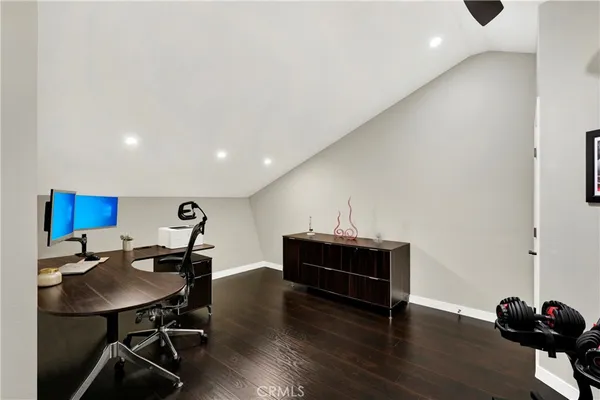a view of a workspace with furniture and wooden floor
