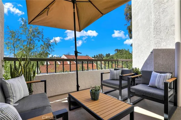 a view of a patio with couches under an umbrella