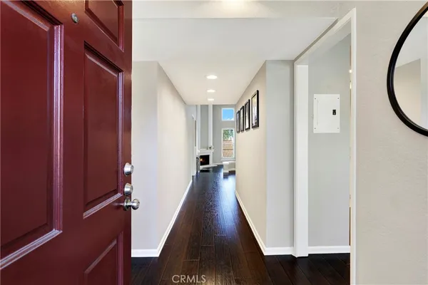 a view of a hallway with wooden floor and staircase