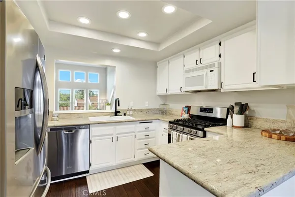 a kitchen with stainless steel appliances granite countertop a sink and cabinets