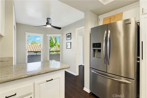 a metallic refrigerator freezer sitting in a kitchen