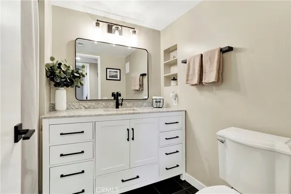 a bathroom with a sink vanity and mirror