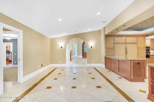 a kitchen with granite countertop cabinets stainless steel appliances and a counter space