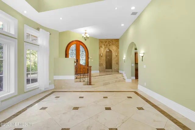 a large white kitchen with a large window