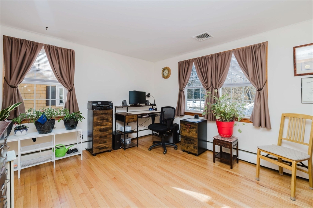 185 Moulton Street Rehoboth, MA 02769 - Photo 27 of 40 a living room with furniture a flat screen tv and a large window