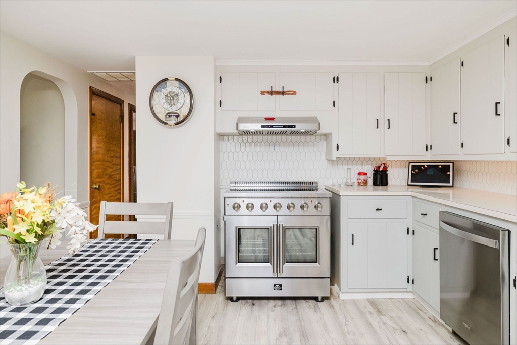 185 Moulton Street Rehoboth, MA 02769 - Photo 5 of 40 a kitchen with a stove oven and a clock on the wall