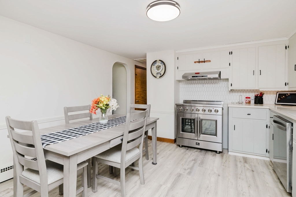 185 Moulton Street Rehoboth, MA 02769 - Photo 6 of 40 a kitchen with granite countertop a stove a sink cabinets and wooden floor
