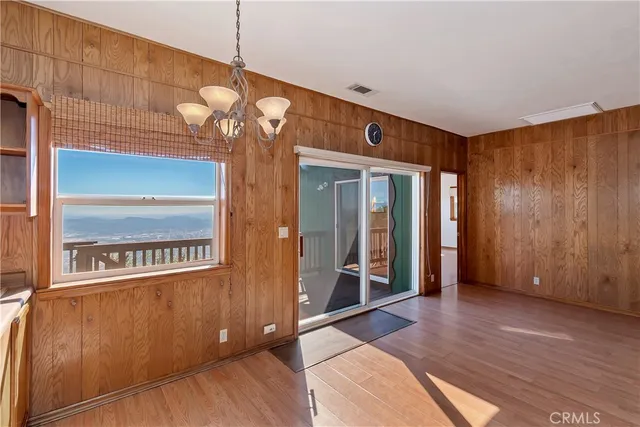 a view of a room with wooden floor and door
