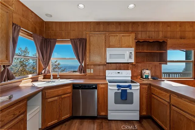 a kitchen with stainless steel appliances granite countertop a stove and a sink