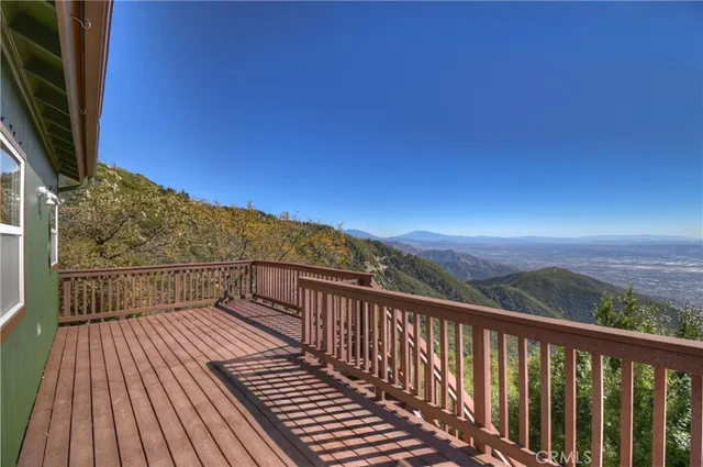 a view of balcony with wooden floor and city view