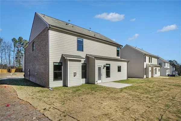 a view of a house with a backyard