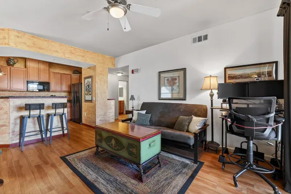 a living room with furniture and a wooden floor