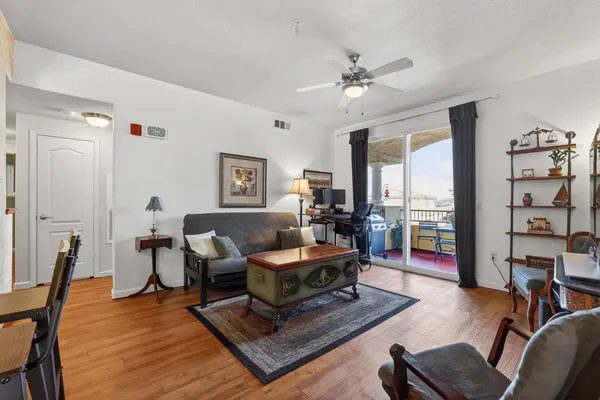 a living room with furniture and wooden floor