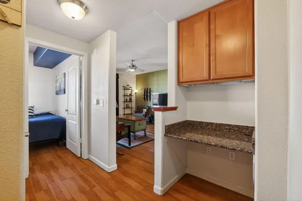 a en suite bathroom with a granite countertop sink and a mirror
