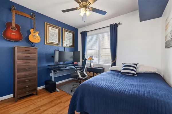 a bedroom with a bed and wooden floor