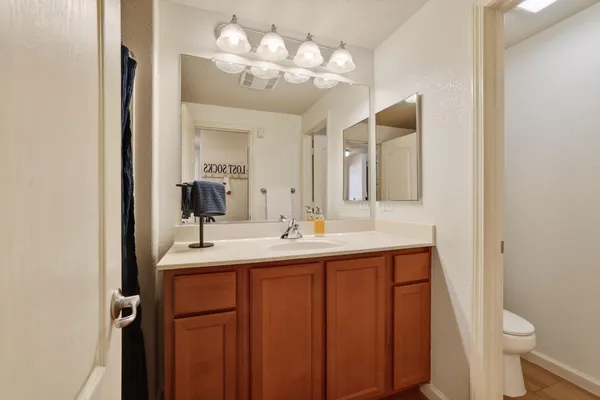 a bathroom with a double vanity sink and a mirror