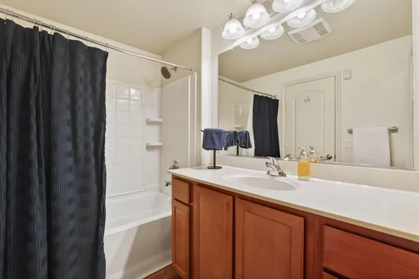 a bathroom with a sink vanity granite and a mirror