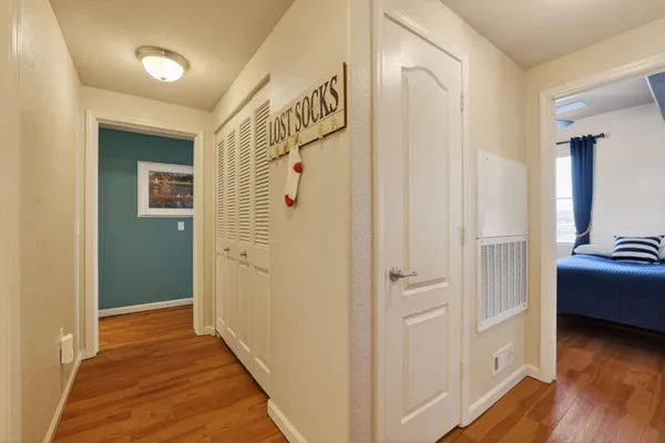 a view of a hallway with wooden floor and staircase