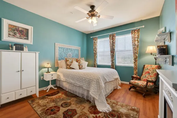 a bedroom with a bed and wooden floor