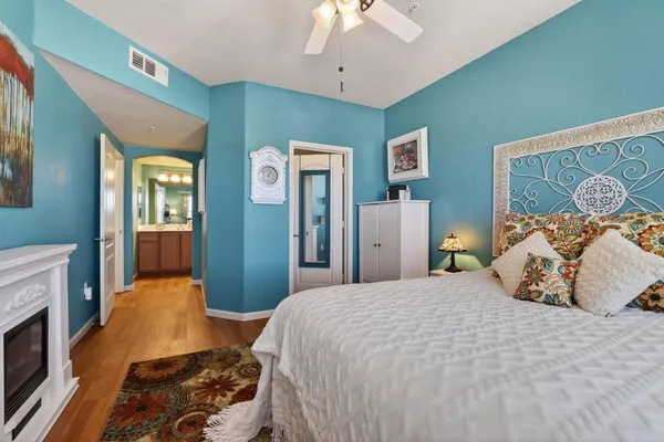 a bedroom with a bed and a chandelier