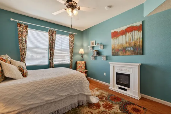 a bedroom with a bed and a fireplace