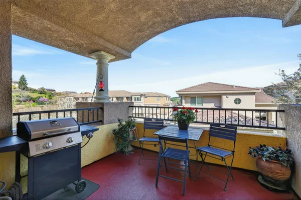 a balcony with wooden floor outdoor seating and city view