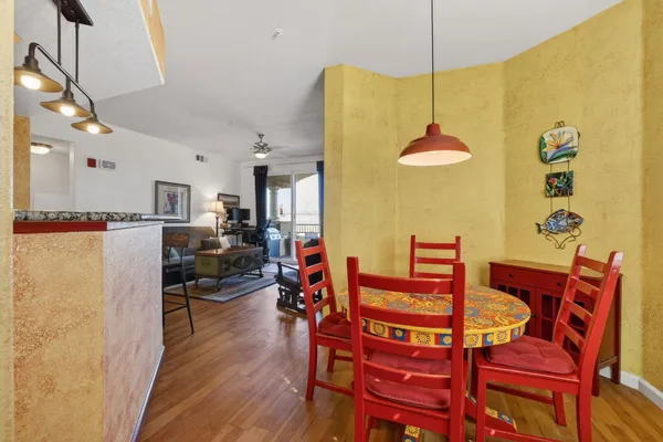 a view of a dining room with furniture and wooden floor