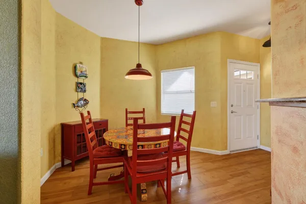 a view of a dining room with furniture and chandelier